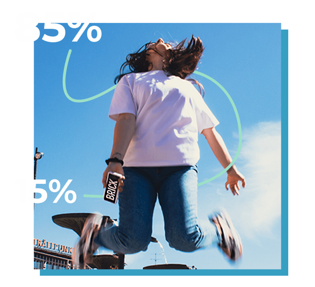 A Brick partner jumping with a powerbank in hand, next to the 85 percent and 15 percent revenue split
